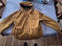 Full view of Element mustard/tan hooded jacket laid flat