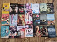 All 21 paperback books laid out in 4x5 grid on floor