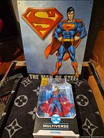 Boxed Superman action figure front view with poster backdrop