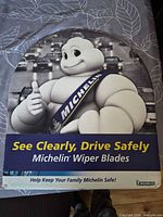 Front view of arch-shaped Michelin advertising sign with slogans