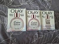 Front view of three boxed Olay serums