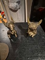 Front view of both brass mouse figurines