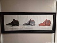 Full view of framed print showing three sneakers