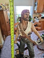 Full view of pirate figurine with tape measure showing height