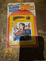 Front view of sealed Superman sliding puzzle on blister card