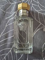 Front view of Versace The Dreamer bottle showing Medusa logo, cap, and fill level