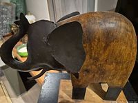 left side view showing wood body, metal ear, base