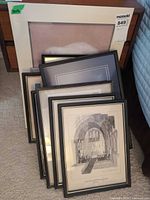 Group shot of seven framed pieces leaning together showing assortment and largest matted photograph