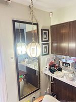 Full view of hanging globe lamp reflected in mirror