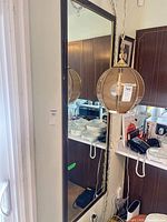 Front view of the rectangular framed mirror mounted on wall