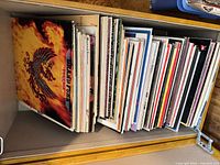 Stack of approximately 45 LPs in storage box