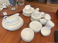 full set of stacked plates, bowls, gravy boat, cups, creamer, sugar bowl