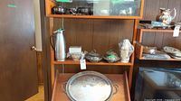 Shelved silver-plate items, stainless carafe, large oval platter