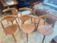 Six teak dining chairs front view