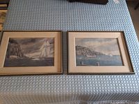 Both framed prints side by side on surface