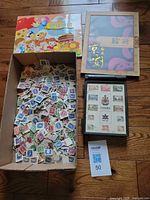 Overview of box of loose stamps and two albums