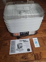 Full view of dehydrator with lid, trays, cord, manual