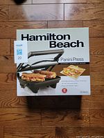 Front of sealed box showing product image and model