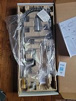 Boxed faucet assembly with hose and instructions