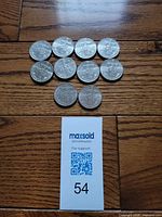All ten coins arranged on wood surface