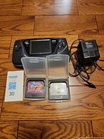 Console, power adaptor, two game cartridges in cases