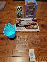 All items: lit LED base with Millennium Falcon panel, Wood Worx kit box, Storm figure and box, extra acrylic panels on floor