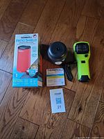 Boxed Patio Shield, E90 unit, MR300 handheld, USB cord and paperwork on floor