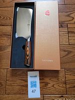Cleaver in open TUO box with MaxSold tag visible