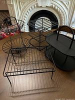 All four matte black metal organizers grouped together on table
