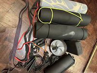 Full lot overview showing mats, bands, trainer, ab wheel, block, roller