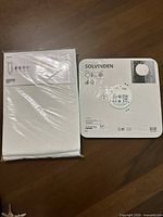 Sealed HILJA curtain pack beside sealed SOLVINDEN lantern backing card