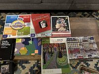All seven game and puzzle boxes arranged on table