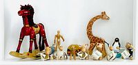 all items arranged on shelf including rocking horse, mannequin, giraffe, leopard, six Anamalz, penguin and snow globe