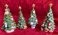 Group shot of four dated Royal Copenhagen Christmas tree figurines