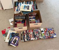 Boxes of assorted paperback books, stacks of People magazines and brochures spread on floor