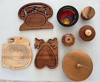 All eight mixed-wood handcrafted pieces laid out on table