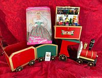 Lot overview showing boxed Barbie, complete wooden train, open Toy Box with figurines
