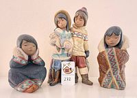 Front view of four Lladró Inuit children figurines