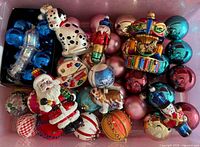 Overview of bin with assorted glass ornaments, various figures and baubles