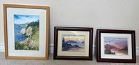 Front view of three framed paintings