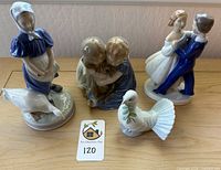 Full group of four Danish porcelain figurines on table