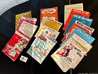 All sheet music pieces spread out to show covers and quantity