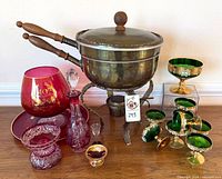 Full lot view showing brass fondue pot, green compotes, ruby glass items