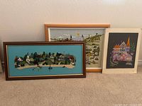 Front view of three embroidery panels showing subjects and framing