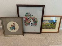 Front view showing all three framed embroidered artworks