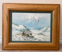Front view of framed signed oil seascape painting