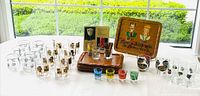Lot overview showing trays, various glasses, shots, booklet, swizzle sticks