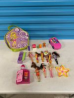 Full lot overview showing dolls, car, cases, furniture