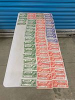 Table view of entire assortment of Canadian Tire money coupons sorted by denomination