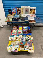 Wide shot of entire lot on tables and bin showing quantity and variety of books